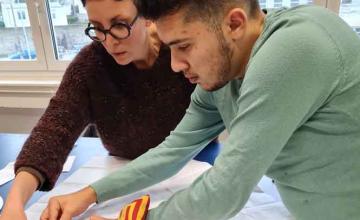 Un élève et une enseignante travaillent sur un patron